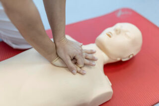 pr class with instructors talking demonstrating first aid compressions and reanimation procedure